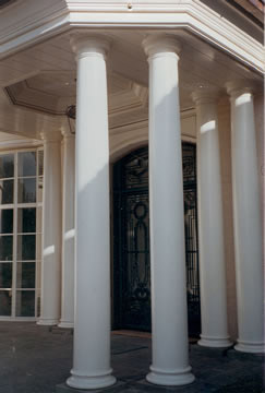 Tall round columns front a commercial building.